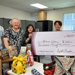 Group of Librarians holding large check smiling at camera