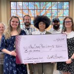 Group of Librarians holding large check smiling at camera