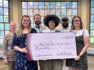 Group of Librarians holding large check smiling at camera